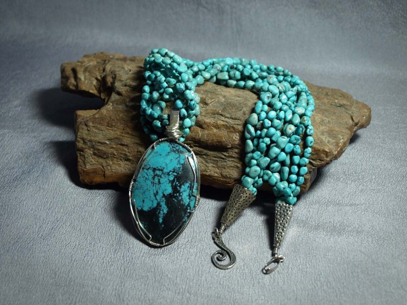 5 Strand Necklace Turquoise Nuggets (3 large / 2 small nuggets), black matte seed beads, white brass cones and sterling silver clasp - 24in and Sterling silver hand wrapped US Turquoise Stone pendent.  Pendent is removable - 3in  Necklace is $200.00 & Pendent is $135.00