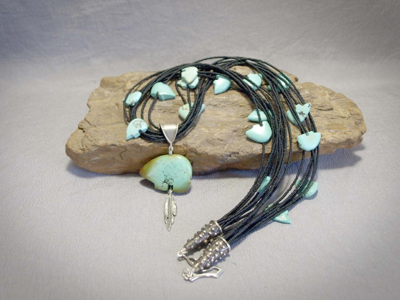 9 strand necklace Black seed beads, Turquoise Bear fetishes, Turquoise Bear pendent, white brass cones and sterling silver components and clasp - 24 in + 3 in Pendent